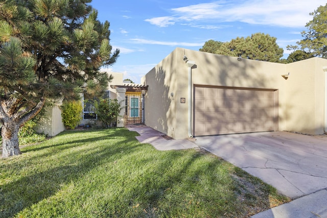 view of front of property with a front yard and a garage