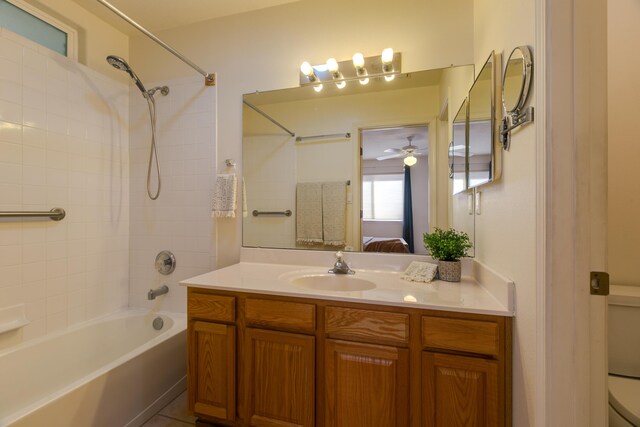 ensuite bathroom with ensuite bath, bathtub / shower combination, toilet, vanity, and a ceiling fan
