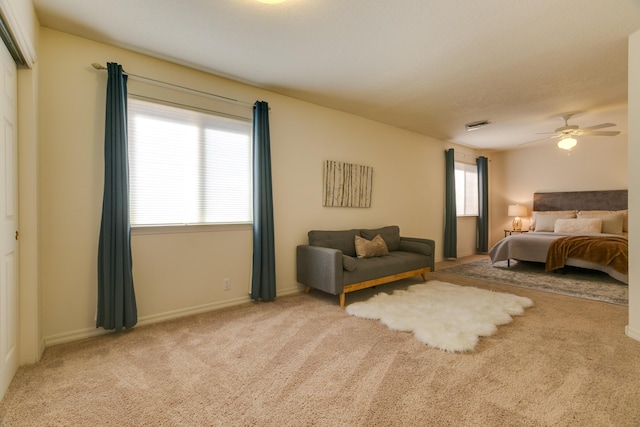 carpeted bedroom with baseboards, visible vents, and ceiling fan