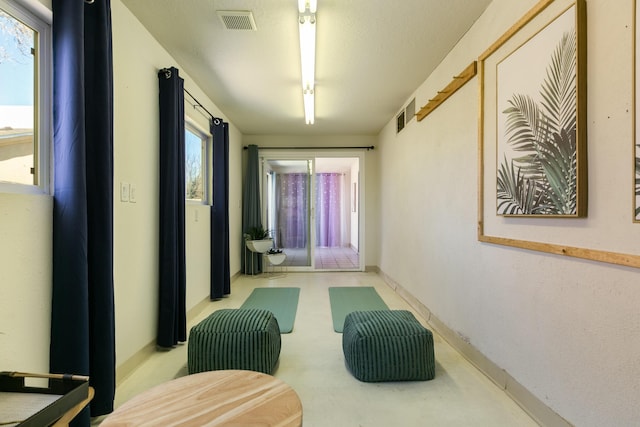 corridor featuring visible vents and baseboards