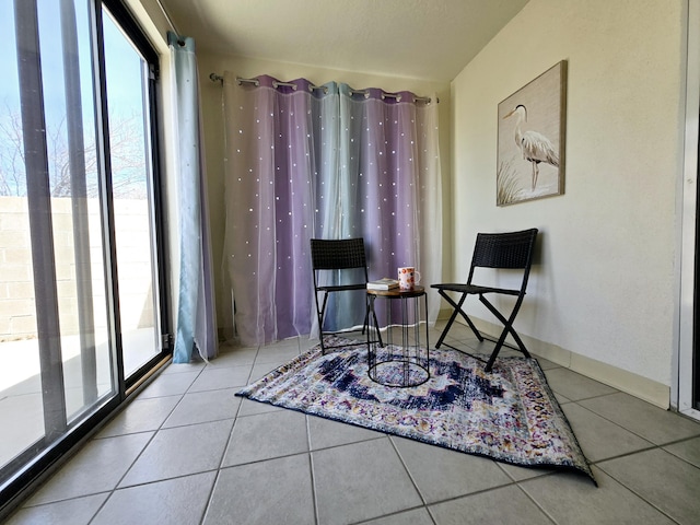 living area with tile patterned flooring and baseboards