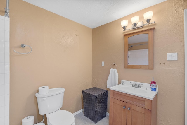 bathroom featuring tile patterned flooring, vanity, a textured ceiling, and toilet