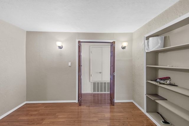 spare room with hardwood / wood-style flooring