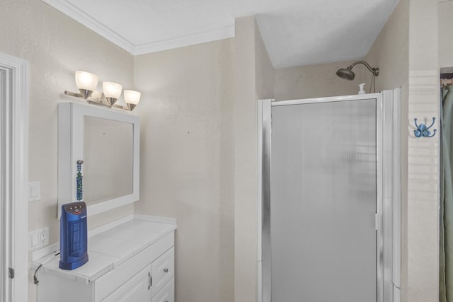 bathroom featuring vanity, a shower with door, and ornamental molding