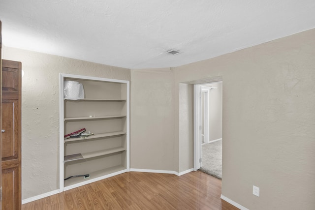 unfurnished room featuring hardwood / wood-style floors