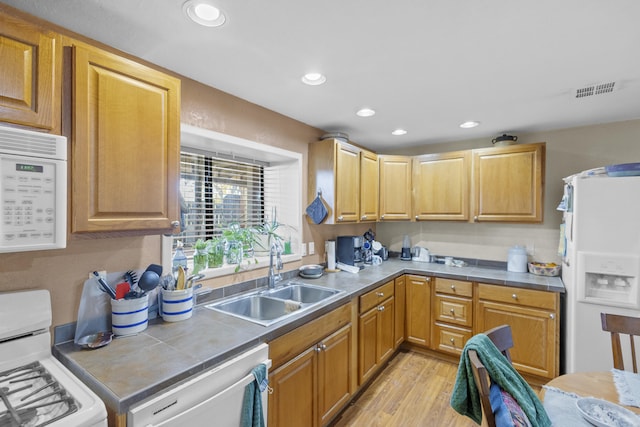 kitchen featuring light wood-type flooring, white appliances, and sink