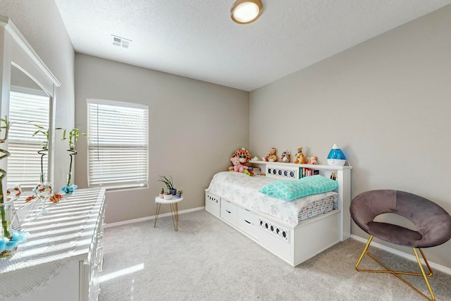 carpeted bedroom featuring a textured ceiling