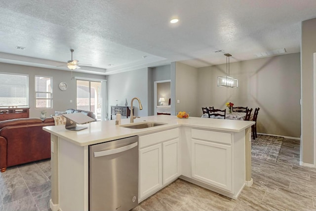 kitchen with white cabinetry, sink, stainless steel dishwasher, an island with sink, and a textured ceiling