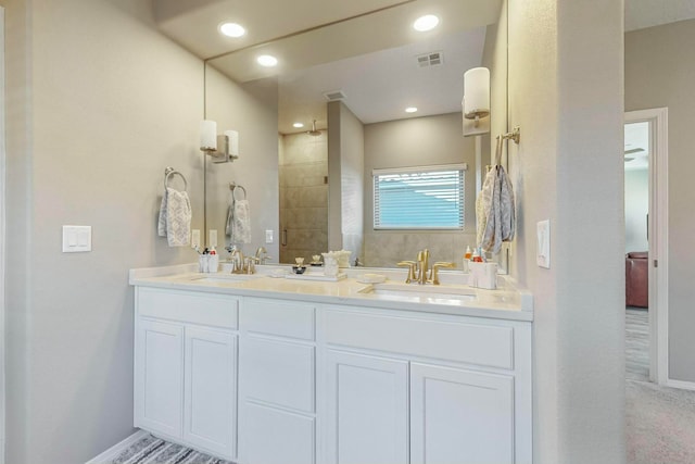 bathroom featuring vanity and an enclosed shower