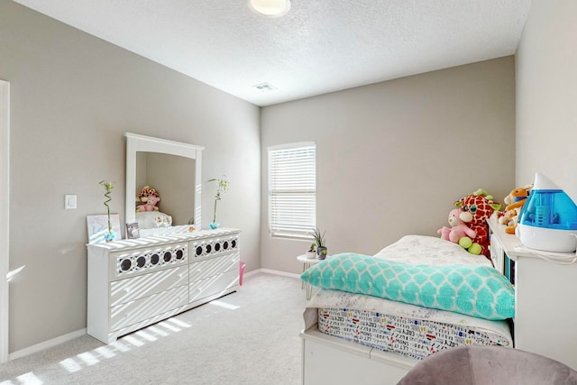 carpeted bedroom with a textured ceiling