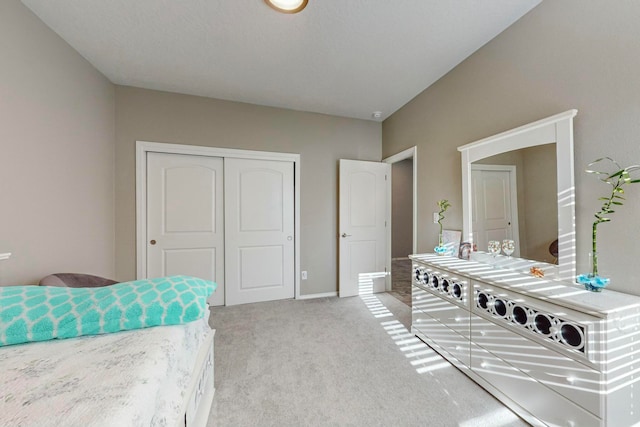 bedroom featuring light carpet and a closet