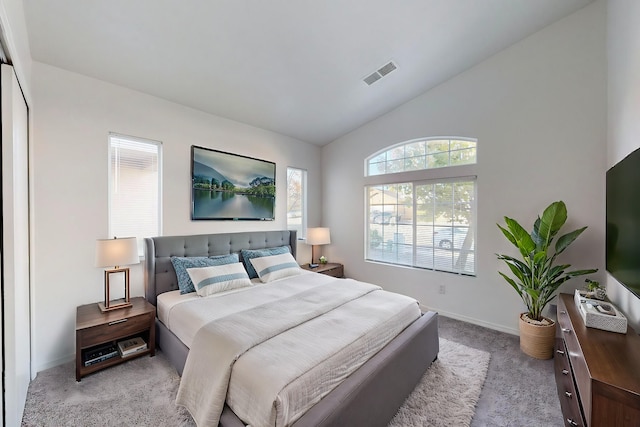 carpeted bedroom with vaulted ceiling