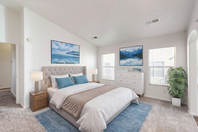 bedroom with lofted ceiling and light carpet