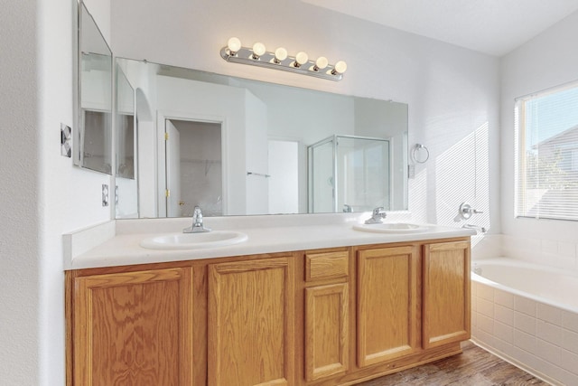 bathroom with vanity, separate shower and tub, and wood-type flooring