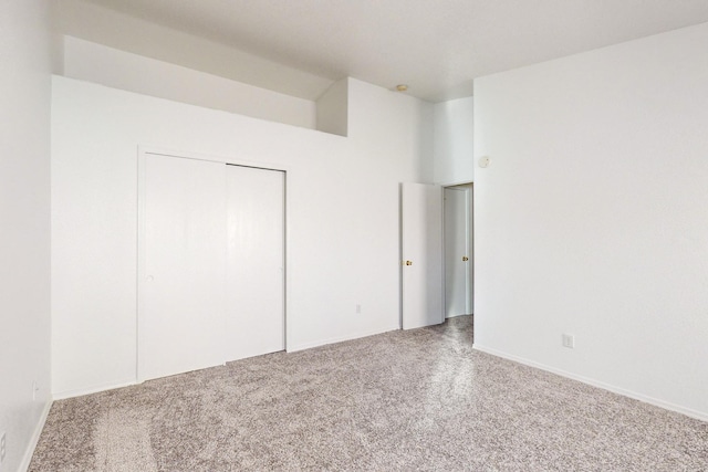 unfurnished bedroom with carpet flooring and a closet