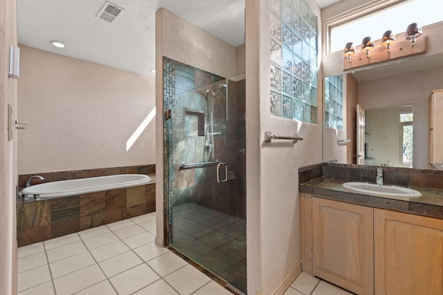 bathroom with tile patterned flooring, vanity, and independent shower and bath