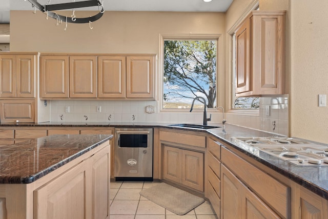 kitchen with stainless steel dishwasher, light tile patterned floors, sink, and tasteful backsplash