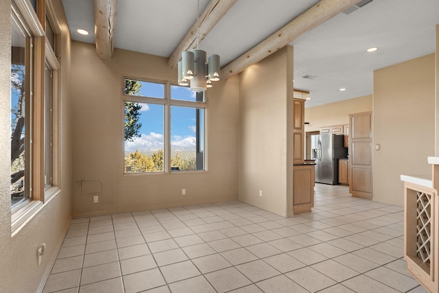 unfurnished room with beam ceiling and light tile patterned floors