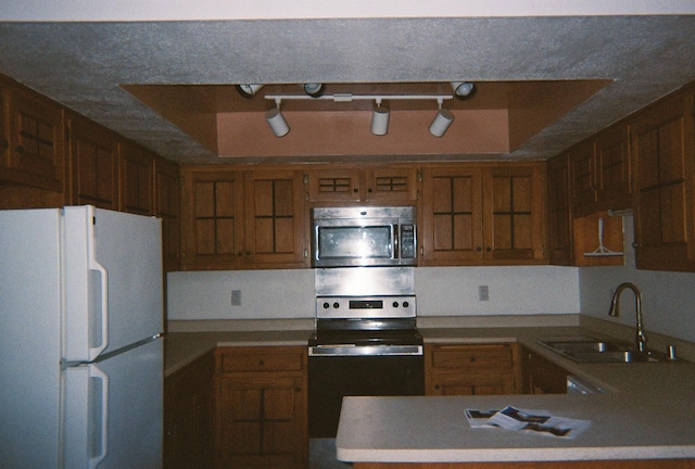 kitchen with stainless steel appliances, sink, and track lighting