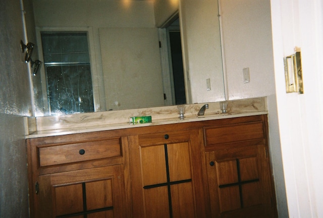 bathroom featuring vanity and an enclosed shower