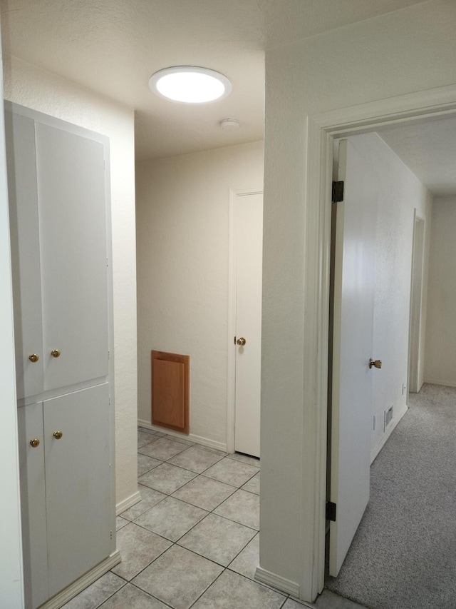 hallway featuring light tile patterned flooring