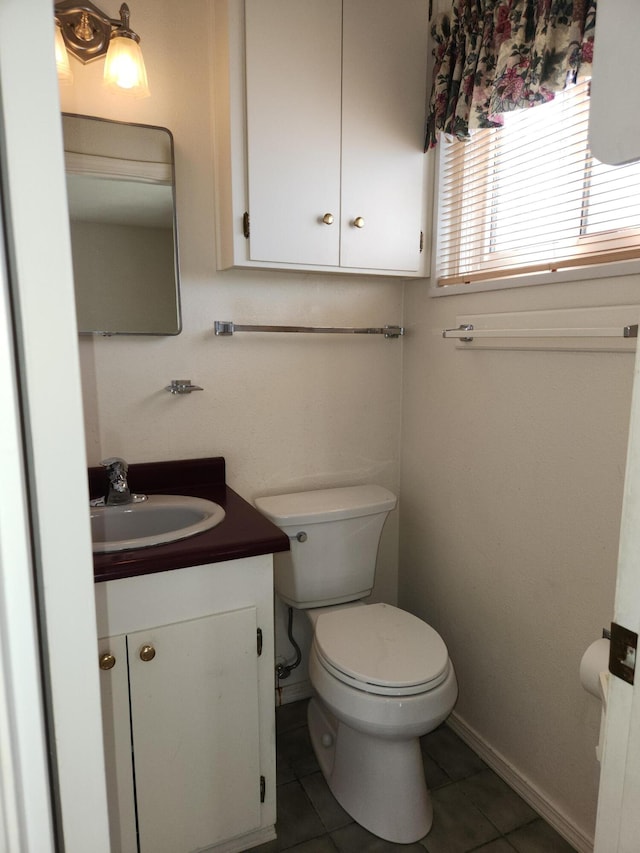 bathroom with tile patterned floors, vanity, and toilet