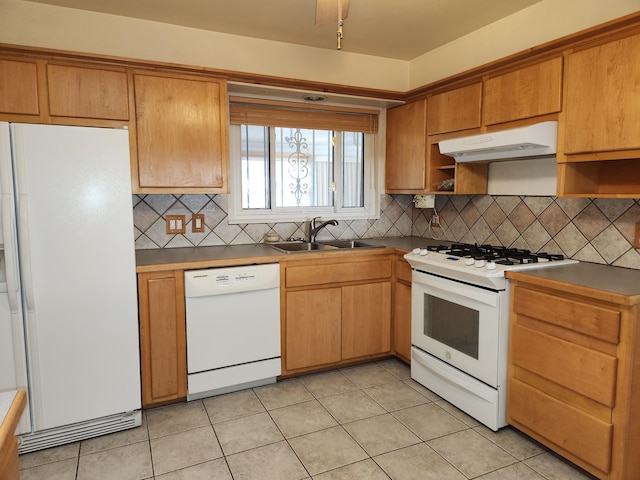 kitchen featuring light tile patterned floors, white appliances, backsplash, and sink