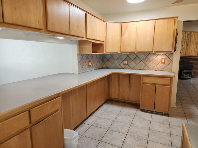 kitchen with light tile patterned floors and tasteful backsplash