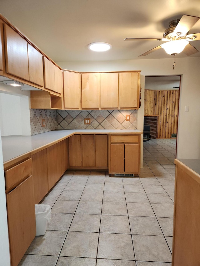 kitchen with light tile patterned flooring, backsplash, and light brown cabinets