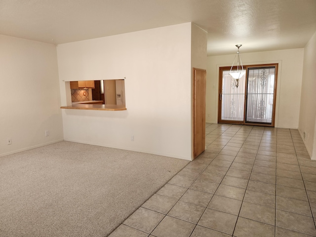 entrance foyer with light tile patterned flooring and a textured ceiling