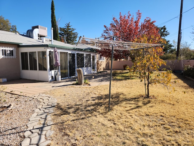 back of property with a sunroom and a patio