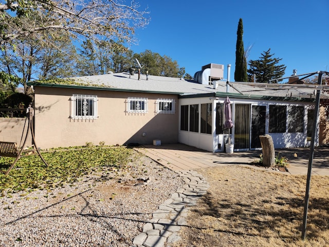 back of property featuring a patio and a sunroom