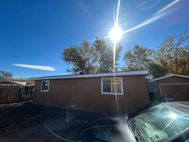 view of home's exterior with a storage shed