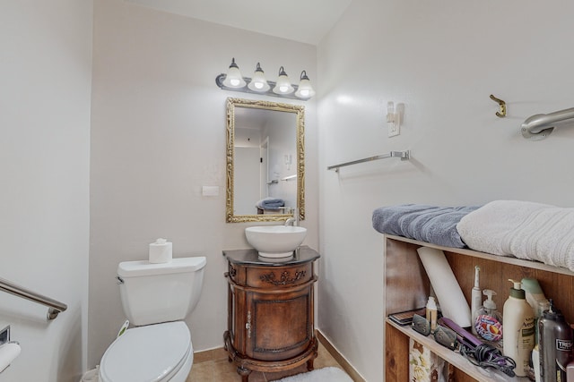 bathroom featuring vanity, tile patterned flooring, and toilet