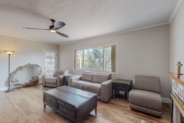 living room featuring crown molding, ceiling fan, a textured ceiling, and light hardwood / wood-style flooring