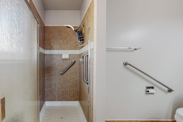 bathroom featuring toilet and an enclosed shower