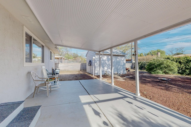 view of patio featuring a storage unit