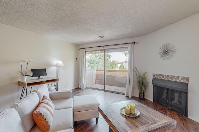 living room featuring hardwood / wood-style floors and a textured ceiling