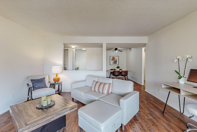 living room featuring dark hardwood / wood-style floors and a textured ceiling