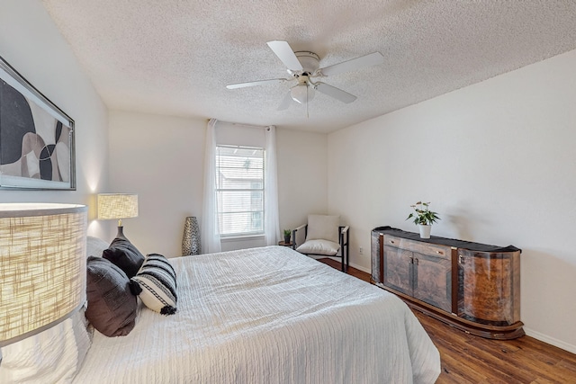 bedroom featuring hardwood / wood-style flooring, ceiling fan, and a textured ceiling