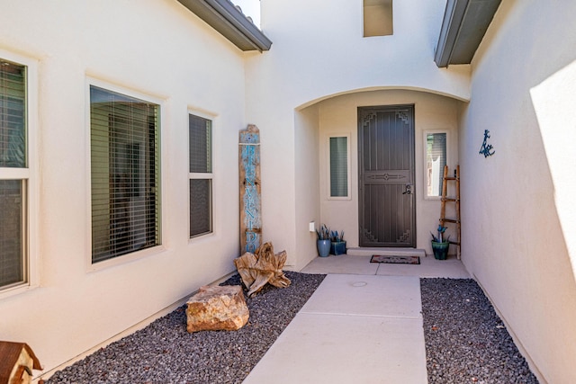 property entrance with stucco siding