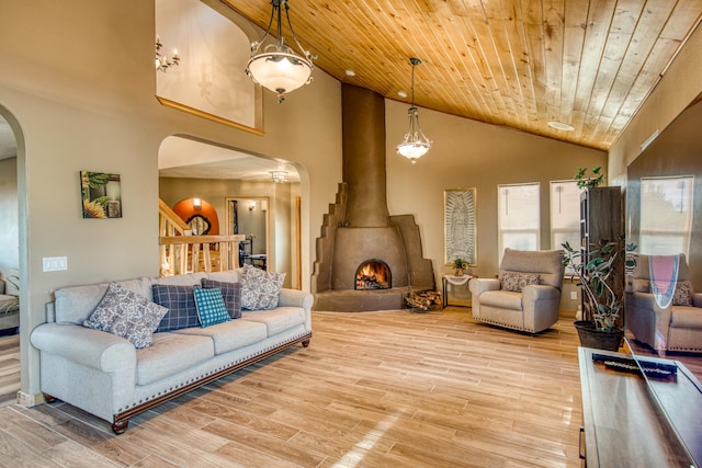 living room featuring hardwood / wood-style floors, a large fireplace, high vaulted ceiling, and wood ceiling