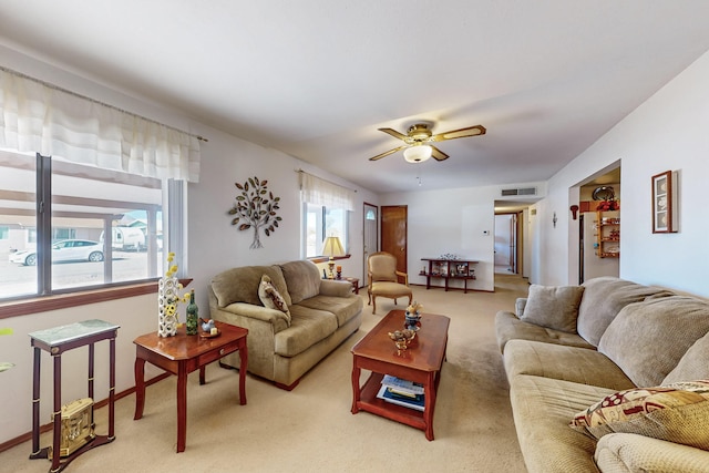 carpeted living room featuring ceiling fan