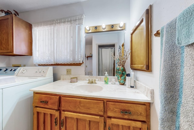 bathroom with vanity and separate washer and dryer