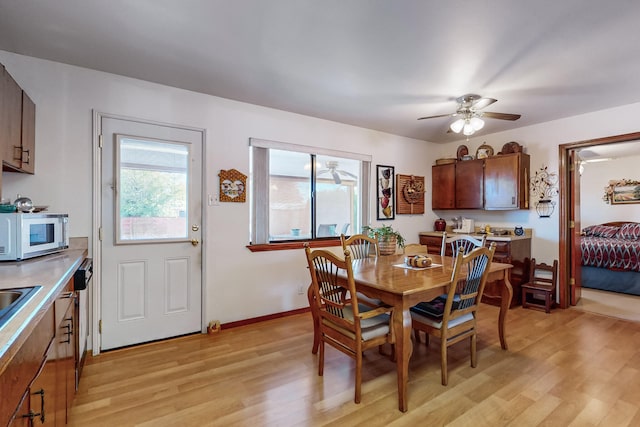 dining area with ceiling fan and light hardwood / wood-style floors