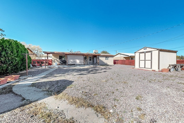 back of property with a storage shed