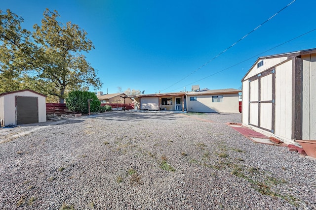 back of property with a shed