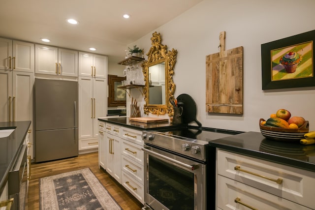 kitchen featuring dark hardwood / wood-style flooring, white cabinets, and stainless steel appliances