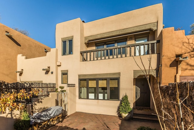 rear view of property featuring a balcony