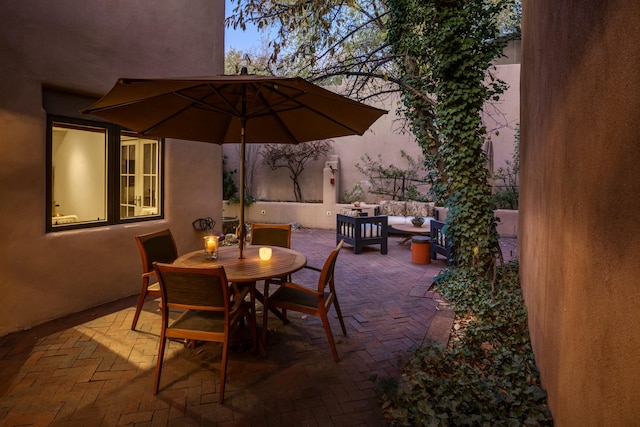 patio terrace at dusk featuring an outdoor living space